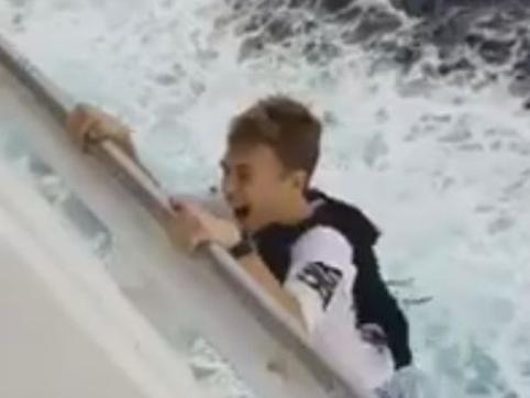 Picture: Twitter/@AnthonyRosale SHOCKING video has emerged showing a teen hanging off the edge of a cruise ship, during a dangerous and potentially deadly stunt. The short video, sent to US TV station KPRC-TV, shows the teenager laughing as he climbs down the side of the Carnival Liberty while at sea off the US coast.