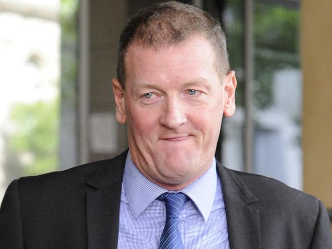 Former AFL player agent Ricky Nixon leaves the Melbourne Magistrates Court in Melbourne, Monday, March 25, 2013. Nixon today recorded a criminal conviction after pleading guilty to the July 2012 bashing of his former fiancee Tegan Gould. (AAP Image/Julian Smith) NO ARCHIVING