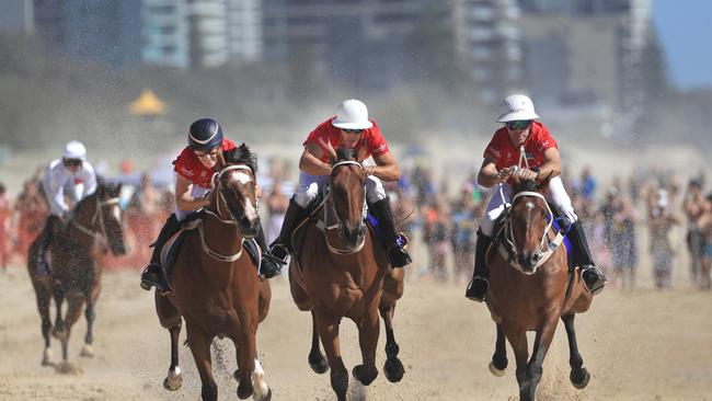 Magic Millions Ambassadors Zara Phillips, Billy Slater and international polo player Nacho Figueras race along Surfers Paradise beach during the Magic Millions Beach Race. Picture: NewsWire / Scott Powick