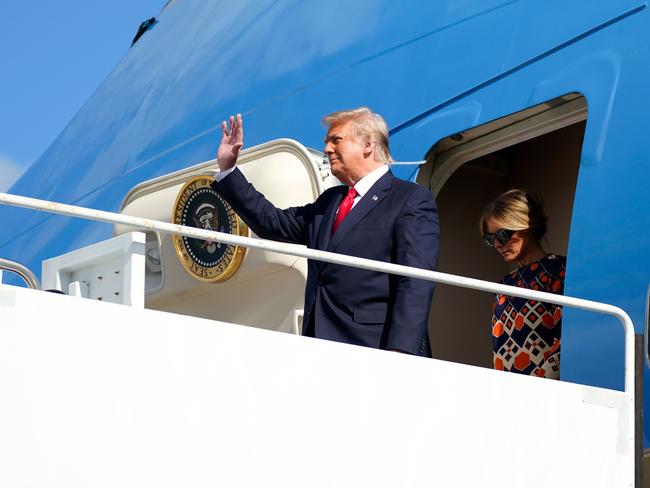 Outgoing US President Donald Trump and US First Lady Melania Trump exit Air Force One as they arrive at Palm Beach International Airport in West Palm Beach, Florida, on January 20, 2021. - President Trump and the First Lady travel to their Mar-a-Lago golf club residence in Palm Beach, Florida, and will not attend the inauguration for President-elect Joe Biden. (Photo by ALEX EDELMAN / AFP)