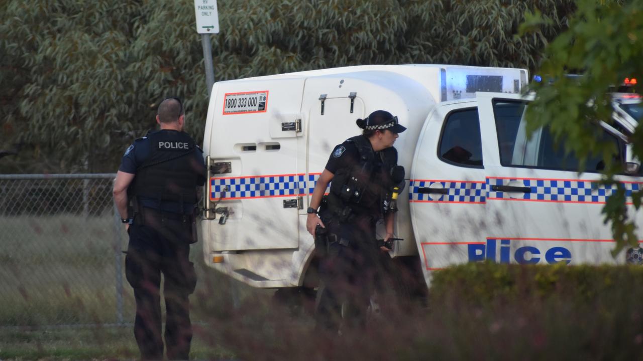 Two of the first officers on scene taking shelter during a police incident in Tara. Picture: Chloe Cufflin