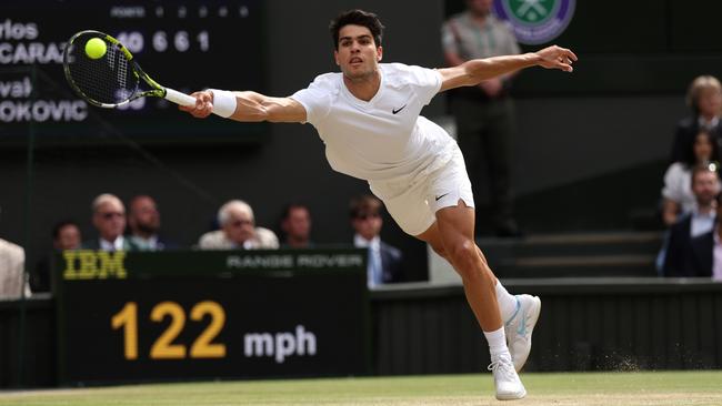 Carlos Alcaraz of Spain stretches to play a forehand against Novak Djokovic. Picture: Getty Images