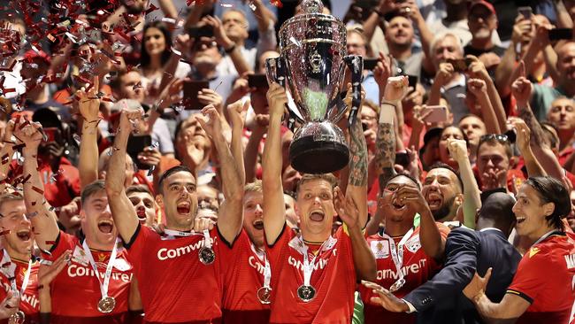 Michael Jakobsen lifts the FFA Cup. Picture: Sarah Reed