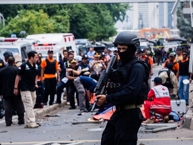 JAKARTA, INDONESIA - JANUARY 14: An Indonesian policeman stands guard in front of a blast site at the Indonesia capital Jakarta on January 14, 2016 in Jakarta, Indonesia. Reports of explosions and gunshots in the centre of the Indonesian capital, including outside the United Nations building and in the front of the Sarinah shopping mall, an area with many luxury hotels, embassies and offices. (Photo by Oscar Siagian/Getty Images)