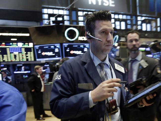 Trader Glenn Kessler, center, works on the floor of the New York Stock Exchange, Wednesday, April 6, 2016. Stocks are wobbling in early trading Wednesday. Health care companies are trading higher, energy companies are rising along with the price of oil and telecommunications companies are slipping. (AP Photo/Richard Drew)
