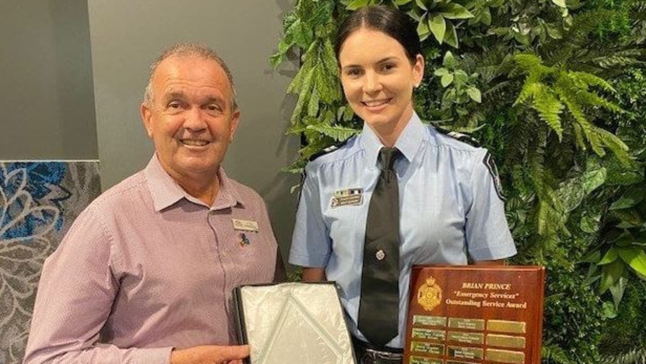 Bundaberg councillor Vince Habermann hands Senior Constable Brittany Duncan her award.