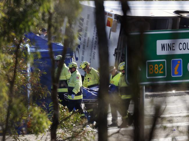 Emergency crews working to remove the bodies at the scene. Pictutre: Jonathan Ng