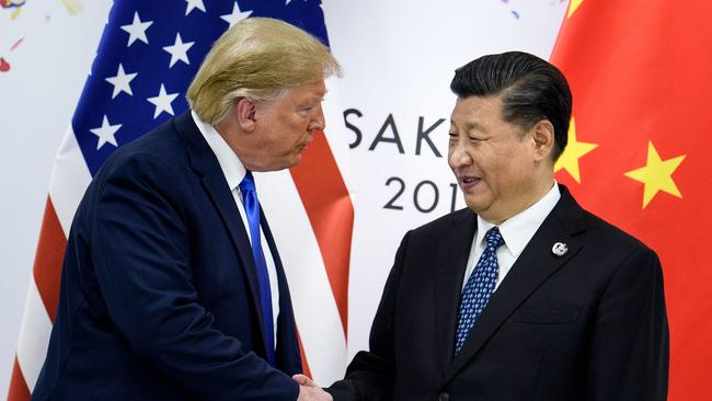 (FILES) In this file photo taken on June 29, 2019 China's President Xi Jinping (R) shakes hands with US President Donald Trump before a bilateral meeting on the sidelines of the G20 Summit in Osaka. - The US public's opinion of China has plummeted amid a surge in strategic and trade tensions in recent years, the Pew Research Center reported on August 13, 2019. The survey group said 60 percent of Americans have an unfavorable view of China, the most in the 14 years since the survey began and up from 47 percent a year ago. (Photo by Brendan Smialowski / AFP)