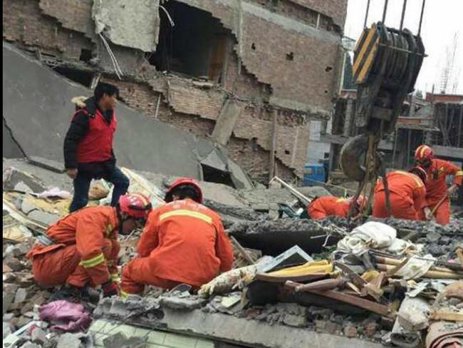 Rescue workers look for survivors buried in the rubble after the apartments collapsed in the industrial city of Wenzhou, China. Picture: Xinhua