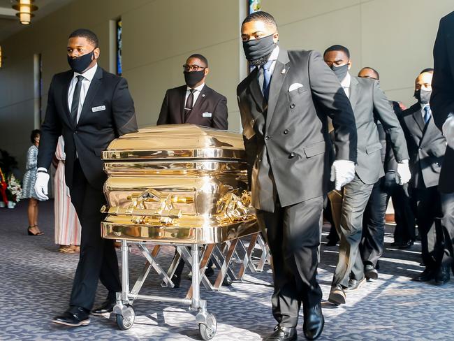 Pallbearers bring the coffin into the church. Picture: AFP