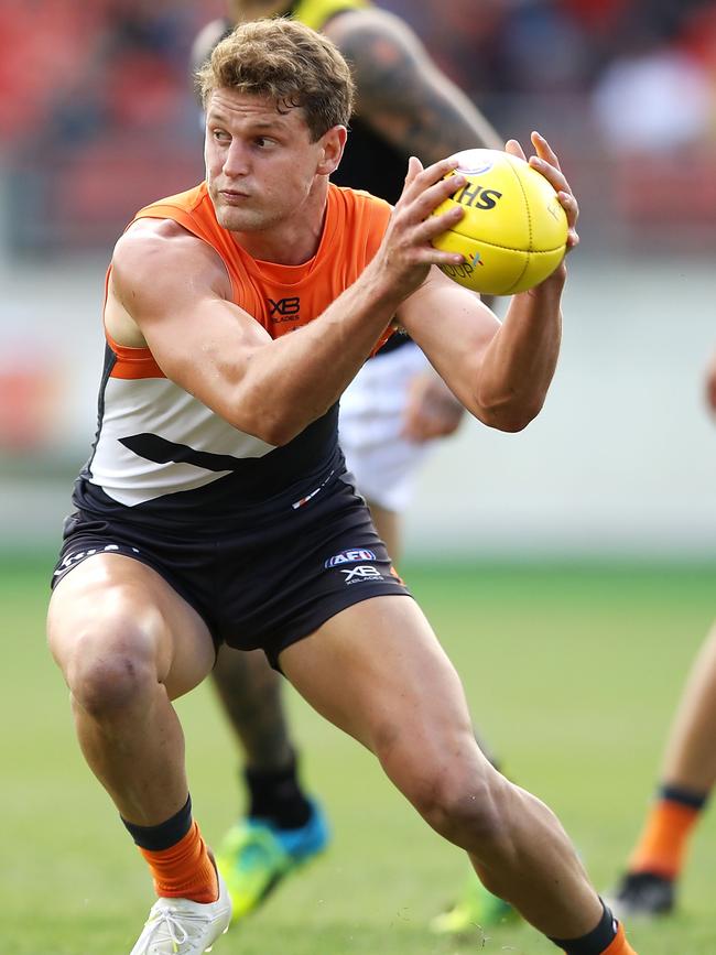 Jacob Hopper weaves past a tackle against Richmond. Picture: Mark Kolbe/Getty Images.