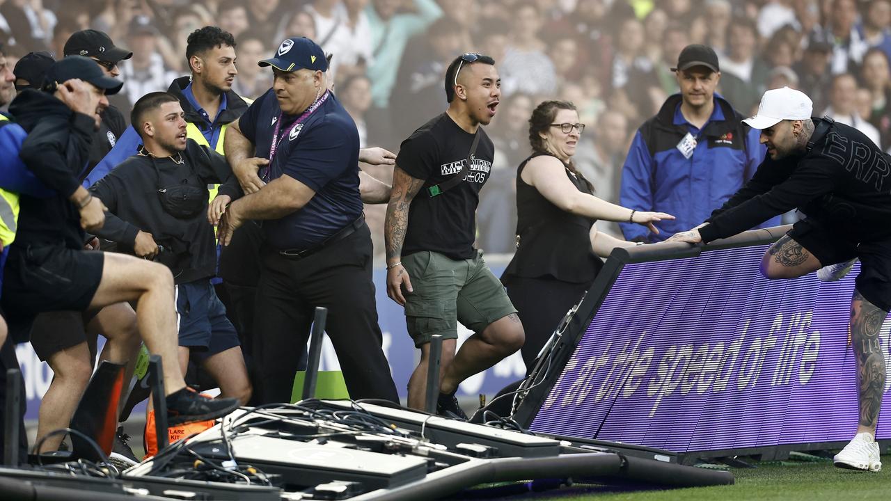 Fans storm the pitch during the round eight A-League match between Melbourne City and Melbourne Victory at AAMI Park. Picture: Darrian Traynor/Getty Images