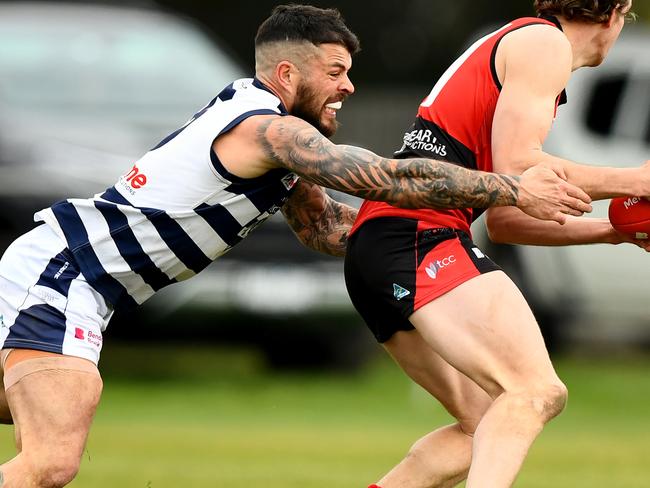 Jaxson Kinnear of Romsey is tackled by Hamish Govan of Macedon during the round 16 Riddell District Football Netball League 2023 Bendigo Bank Seniors match between Romsey and Macedon at Romsey Park in Romsey, Victoria on August 5, 2023. (Photo by Josh Chadwick)