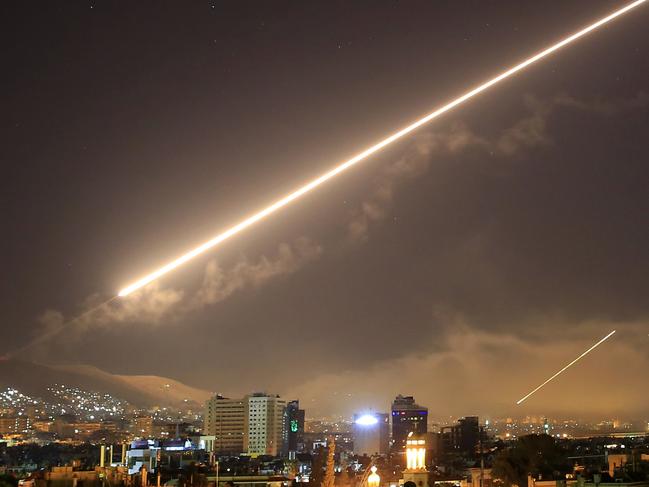 Damascus skies erupt with surface to air missile fire as the U.S. launches an attack on Syria targeting different parts of the Syrian capital Damascus, Syria, early Saturday, April 14, 2018. Syria's capital has been rocked by loud explosions that lit up the sky with heavy smoke as U.S. President Donald Trump announced airstrikes in retaliation for the country's alleged use of chemical weapons. (AP Photo/Hassan Ammar)