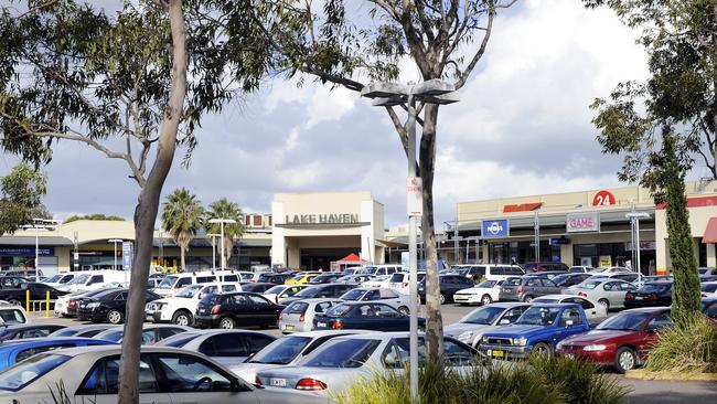 A man has been charged after allegedly coughing on customers and staff at Lake Haven Shopping Centre.