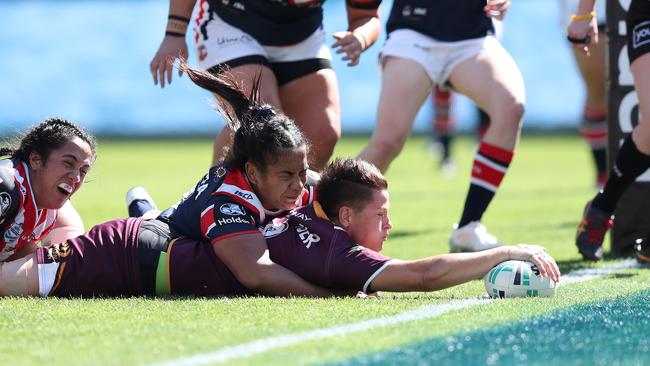 Heather Ballinger plants the ball down to score a try for the Broncos. Picture: Brett Costello