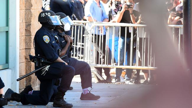 Police officers kneel in San Francisco, California, on Thursday. Picture: AFP