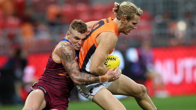 Brisbane’s Mitch Robinson puts the clamps on Giant Nick Haynes. Picture: Phil Hillyard