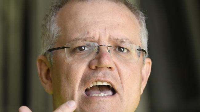 Federal Treasurer Scott Morrison gestures during a doorstop during a visit to a glass factory in Brisbane, Monday, May 14, 2018. (AAP Image/Dave Hunt) NO ARCHIVING