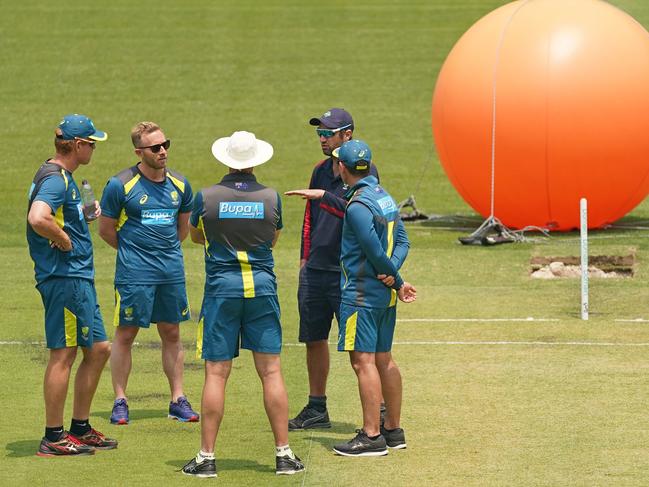 MCG curator Matt Page talks to Justin Langer, assistant coach Andrew McDonald and Dovey ahead of the Boxing Day Test match between Australia and New Zealand, at the MCG in December, 2019. (AAP Image/Scott Barbour).