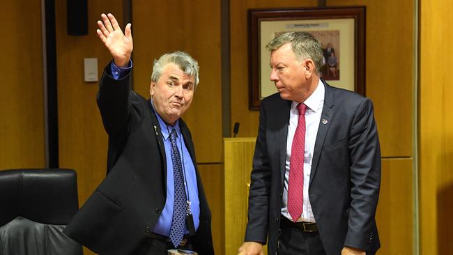 Former councillor David Pahlke waves goodbye as then acting mayor Wayne Wendt looks on following the Ipswich City Council's final meeting in August 2018.