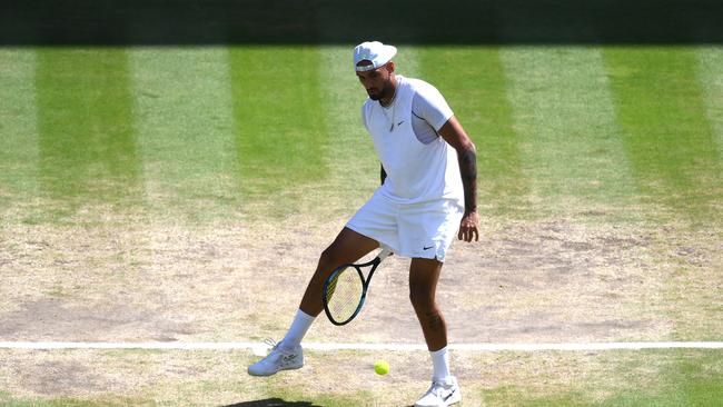 LONDON, ENGLAND - JULY 10: Nick Kyrgios of Australia plays a tweener against Novak Djokovic of Serbia during their Men's Singles Final match on day fourteen of The Championships Wimbledon 2022 at All England Lawn Tennis and Croquet Club on July 10, 2022 in London, England. (Photo by Shaun Botterill/Getty Images)