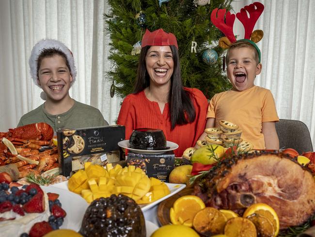 Rosie Waters and her sons Harvey (11) and Hugo (6) enjoy Christmas Lunch. The most popular Christmas food/items in each state. Queenslanders: ham, cherries and mangoes -NSW customers: seafood Ã prawns, salmon and oysters -Victorians: lobsters -South Australians: pavlovas -Tasmanians: top wrapping paper purchases. Picture: Jake Nowakowski