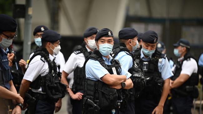 Police keep watch outside the court in Hong Kong on Monday. Picture: AFP