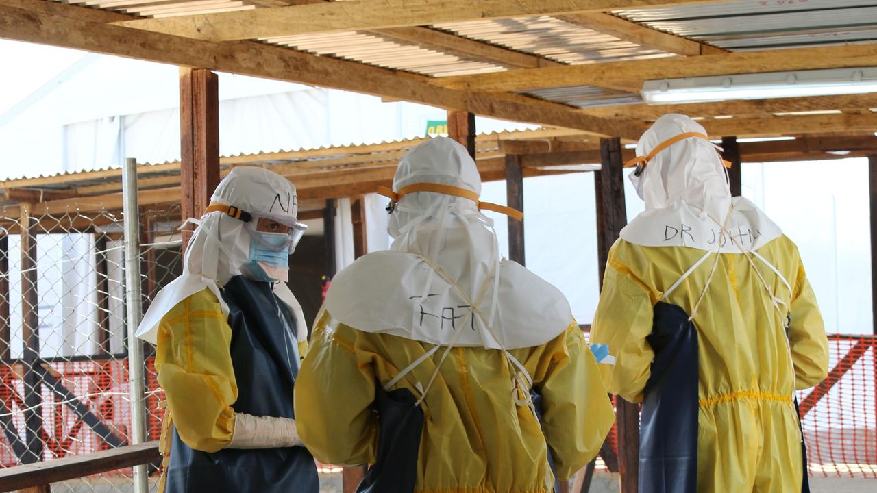 Dr John Gerrard, right, and team entering the ebola treatment centre red zone in Sierra Leone.