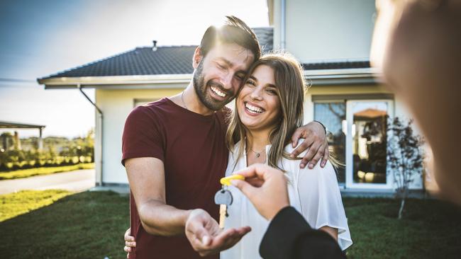 NEWS360 Commercial. Happy millennial couple receiving keys from Real Estate Agent, purchasing real estate - Family meeting with real estate agent - New house and real estate concept. Picture: iStock