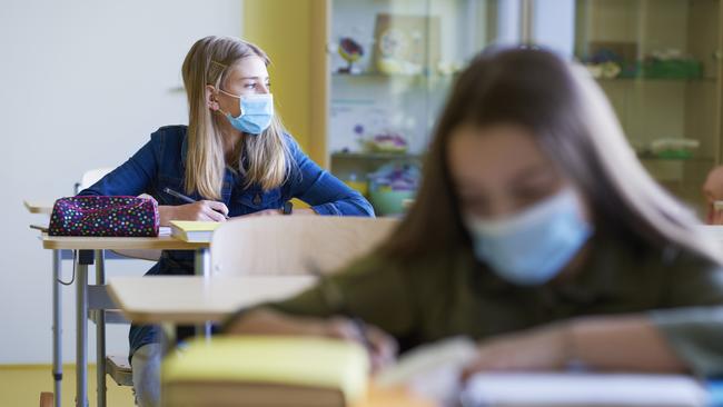 Schoolgirls learning in the classroom during a pandemic