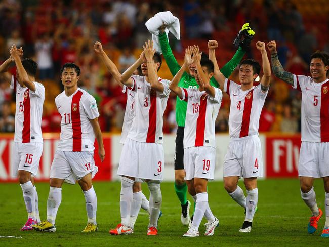 (FILES) This file photo taken on January 14, 2015 shows China's team saluting fans following the first round Asian Cup football match between China and Uzbekistan at the Suncorp Stadium in Brisbane. High-flying China have emerged as the Asian Cup's dark horses after their best start to the competition in 27 years emphatically put the cat among the pigeons. AFP PHOTO / FILES / PATRICK HAMILTON ---IMAGE RESTRICTED TO EDITORIAL USE - STRICTLY NO COMMERCIAL USE---