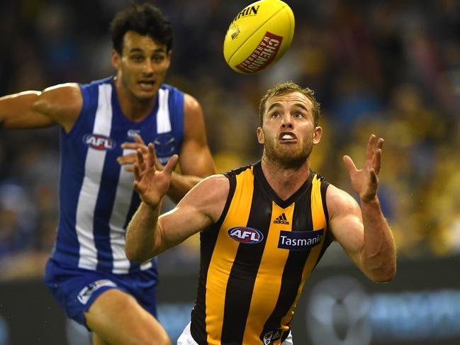 Tom Mitchell of the Hawks (right) is seen in action during the Round 5 AFL match between the North Melbourne Kangaroos and the Hawthorn Hawks at Etihad Stadium in Melbourne, Sunday, April 22, 2018. (AAP Image/Julian Smith) NO ARCHIVING, EDITORIAL USE ONLY