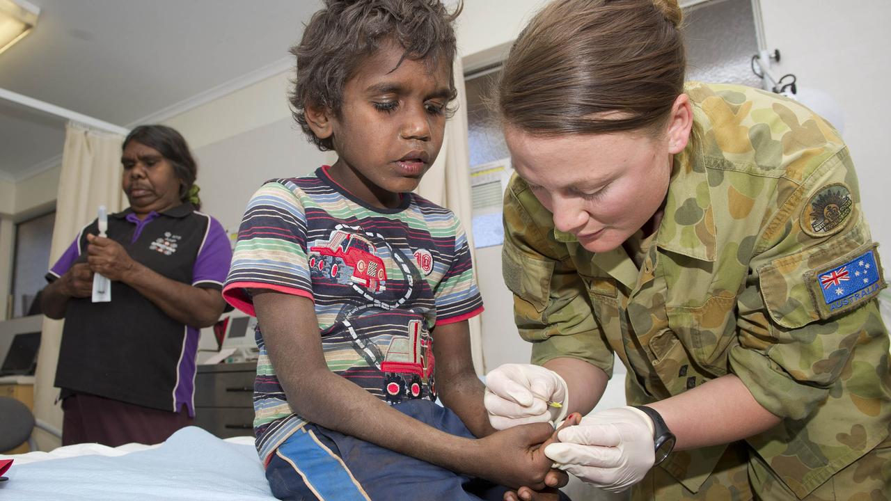 Australian Army officer Lieutenant Stephan Halliday, a nurse from the Army Aboriginal community Assistance Program, conducts a health check for Stefan Epennara from the Wutunugurra community.