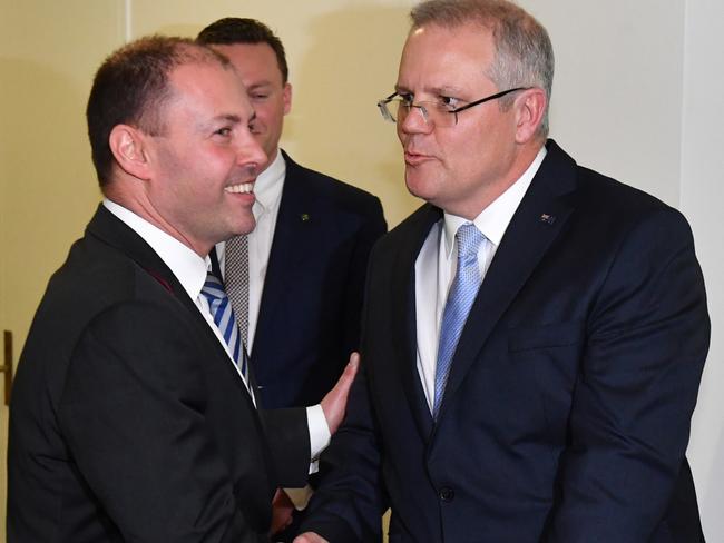 Newly elected deputy Liberal leader Josh Frydenberg happily shakes hands with Mr Morrison after they leave the meeting. Picture: Mick Tsikas/AAP