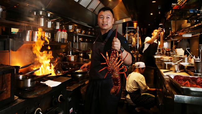 Mr Wong chef Felix Wongso prepares to cook an Australian lobster in Sydney as prices fall to an all time low, creating a boom for restaurants. Picture: Jane Dempster