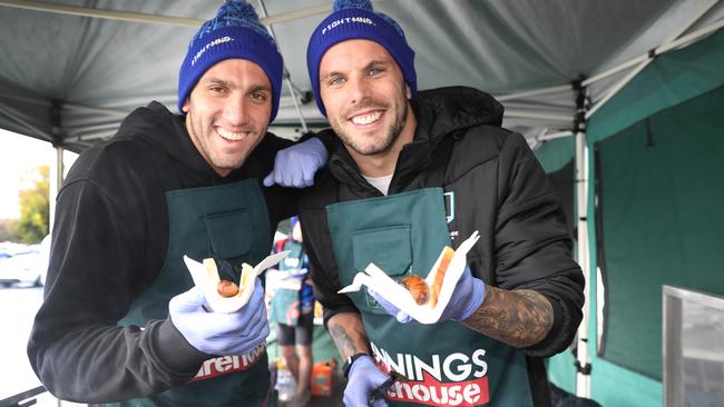 Zac Incerti and Kyle Chalmers serving up snags at Bunnings Mile End, in support of charity MND, May 2022. Picture: Dean Martin