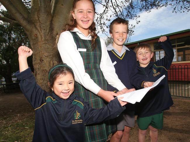 School captains Avery Howard and Eamon Loney with preps Alina Luong and Toby Grant. St Patrick's Primary School in Geelong West will receive $3.6million to fund the construction of new buildings. The buildings in the background will be demolished to make way for the new development. Picture: Alan Barber