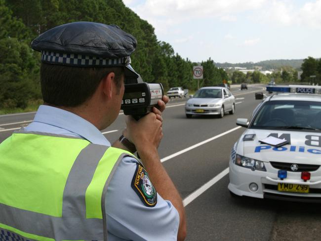 APRIL 12, 2004: Sergeant Dave Collis from Brisbane Water Highway Patrol using a radar gun to detect speeding vehicles on the Pacific Highway at Kariong, 12/04/04. Pic Liam Driver.NSW