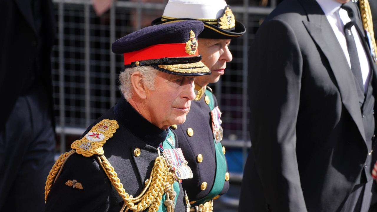 Britain's King Charles III and Britain's Princess Anne, Princess Royal walk behind the hearse carrying Queen Elizabeth II's coffin during the procession from Palace of Holyroodhouse to St Giles' Cathedral on September 12. Photo by Owen Humphreys/WPA Pool/Getty Images