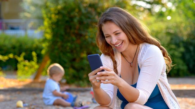 A young mobile using her mobile phone to text a friend.