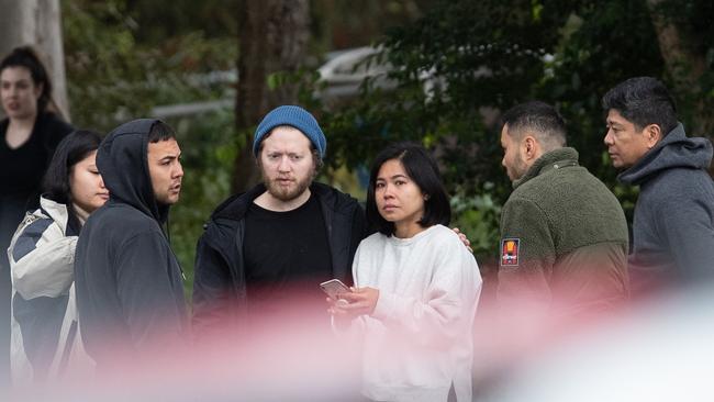 Mourners gather at the scene of the blaze.