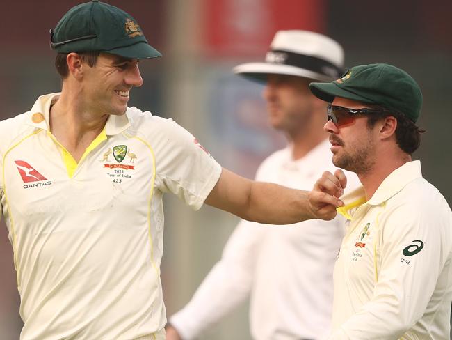 DELHI, INDIA - FEBRUARY 17: Pat Cummins speaks with Travis Head of Australia as they walk off the ground at the end of play during day one of the Second Test match in the series between India and Australia at Arun Jaitley Stadium on February 17, 2023 in Delhi, India. (Photo by Robert Cianflone/Getty Images)