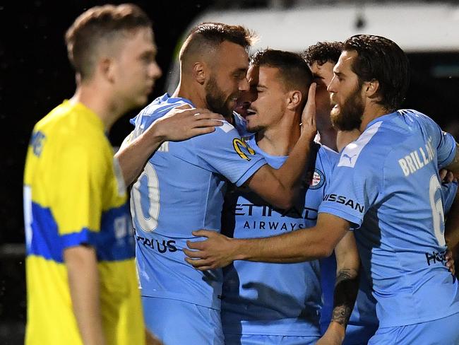 Jamie Maclaren of Melbourne City (2nd right) celebrates scoring a goal with teammates during the FFA Cup semi-final match between the Brisbane Strikers and Melbourne City FC at Perry Park in Brisbane, Tuesday, October 1, 2019. (AAP Image/Dan Peled) NO ARCHIVING, EDITORIAL USE ONLY