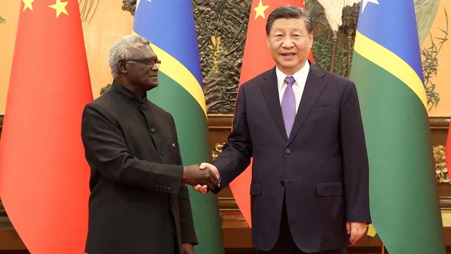 Chinese President Xi Jinping and Solomon Islands Prime Minister Manasseh Sogavare shake hands at the Great Hall of the People in Beijing earlier this month.