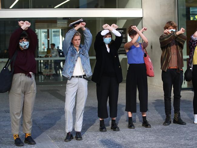 Protesters stand outside the Supreme Court in Brisbane Picture: NCA NewsWire / Jono Searle