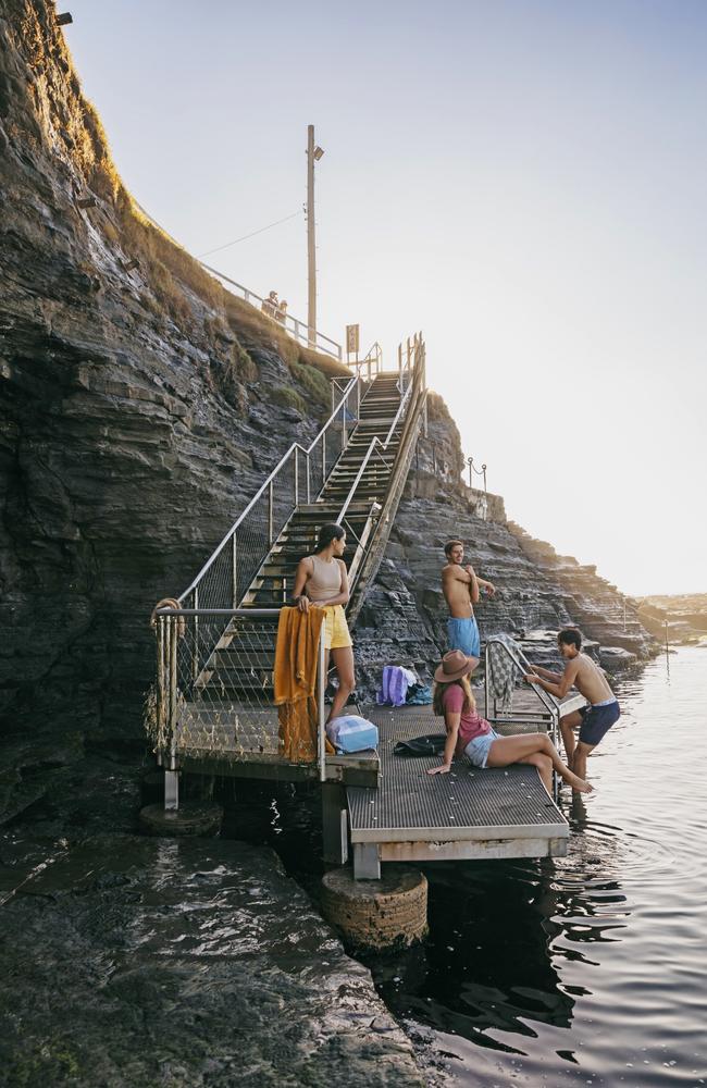 Young people enjoying a swim at Bogey Hole ocean pools in Newcastle at sunrise. Picture: Destination NSW