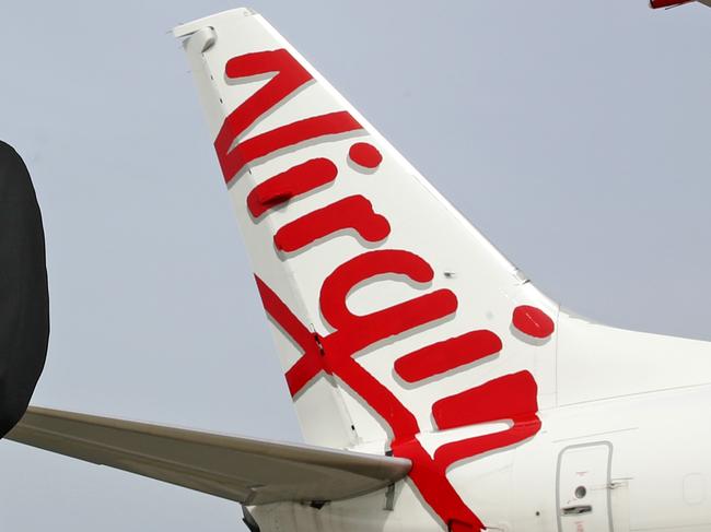 FEDERAL BUDGET CASE STUDY - Virgin pilots and father and son team Max and Daniel Jamieson pictured in front of a Boeing 737 at Sydney Airport. Max (R) has been a domestic pilot with Virgin for 14 years and son Daniel just lost his job on the long haul legs flying the Boeing 777. Picture: Toby Zerna