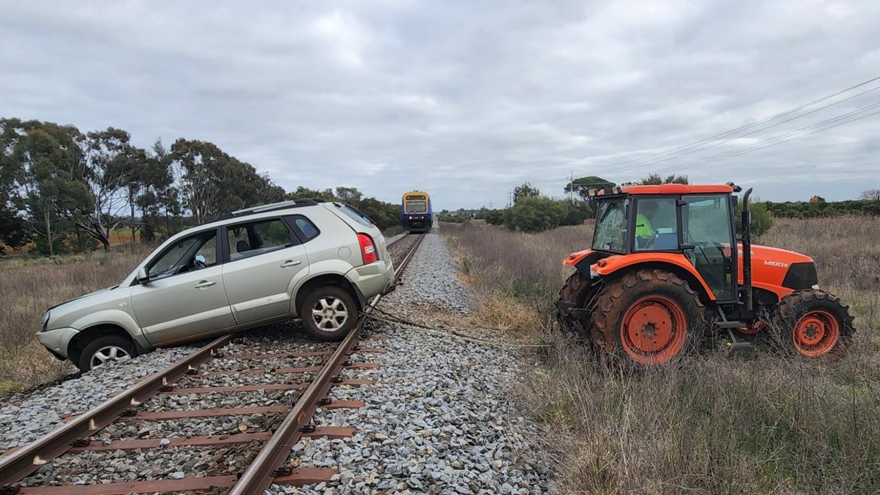A farmer used his tractor to help police pull the car from the tracks. NSW Traffic and Highway Patrol