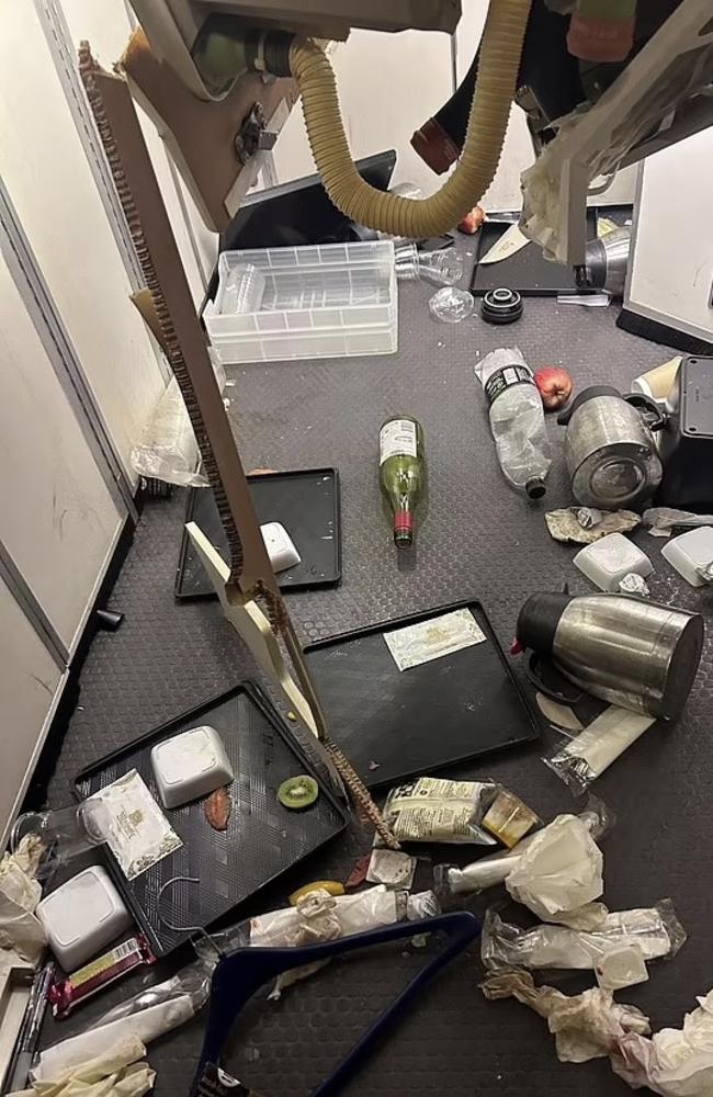 Food and drink trays and other bottles that fell after the mayhem onboard. Picture: X/Twitter